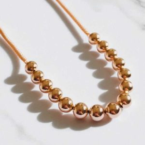 Colar chocker bolas folheado à ouro