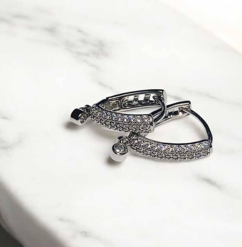 Brinco solitário cravejado em zircônias folheado à ouro branco